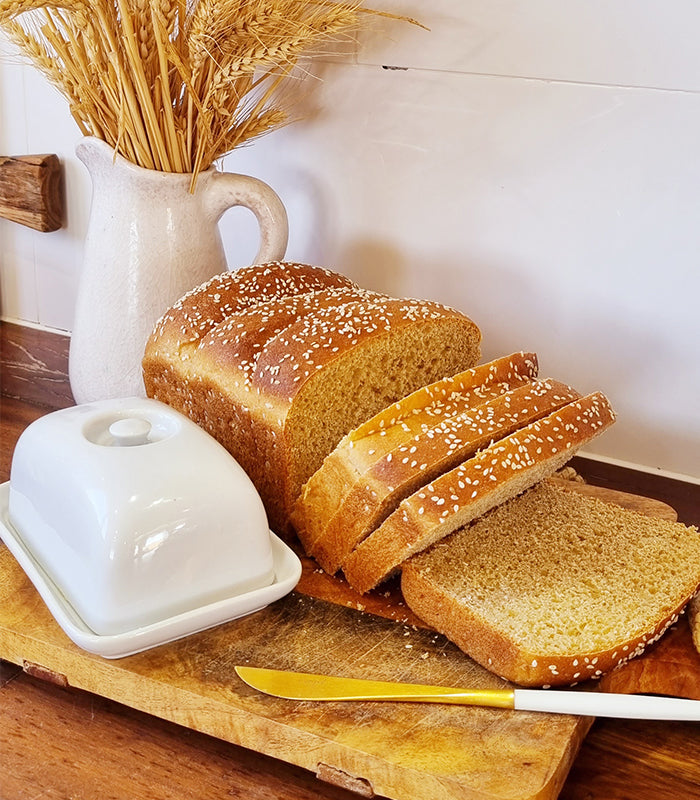 Fresh homemade bread baked with stoneground flour, sliced and served on a wooden board as a first-time bread bake