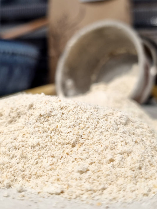 Stone-milled sifted flour from the Sifted Flour Box by Sieda Milling, shown being poured for everyday baking
