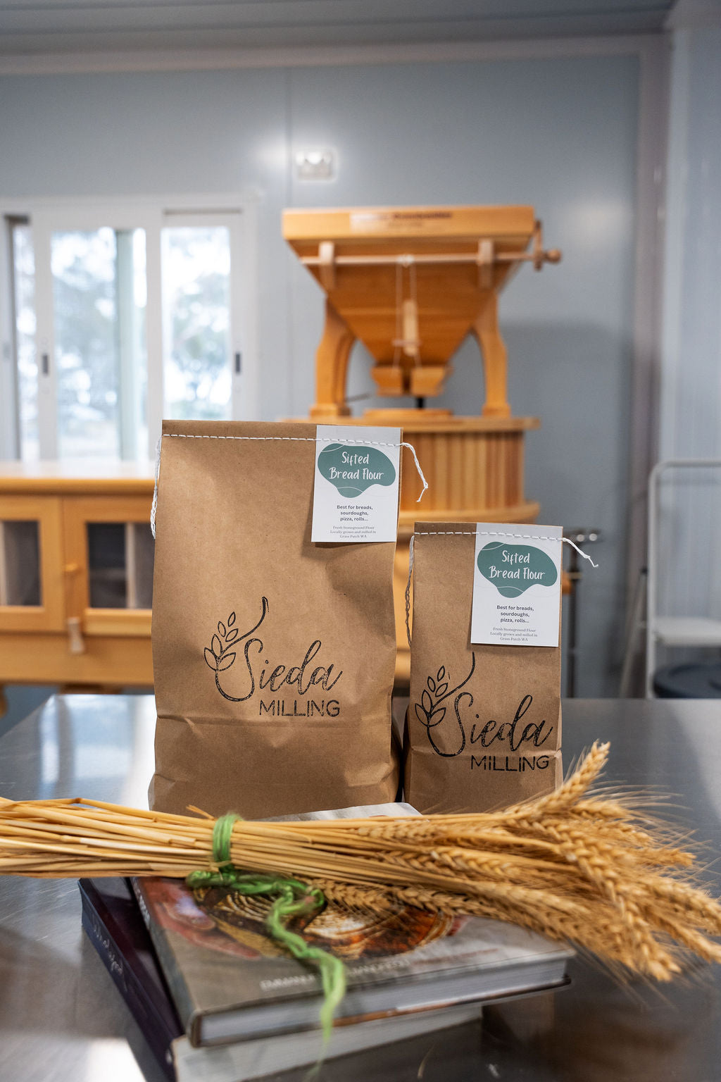 Stone-milled sifted bread flour by Sieda Milling, shown with wheat and artisan baking setup