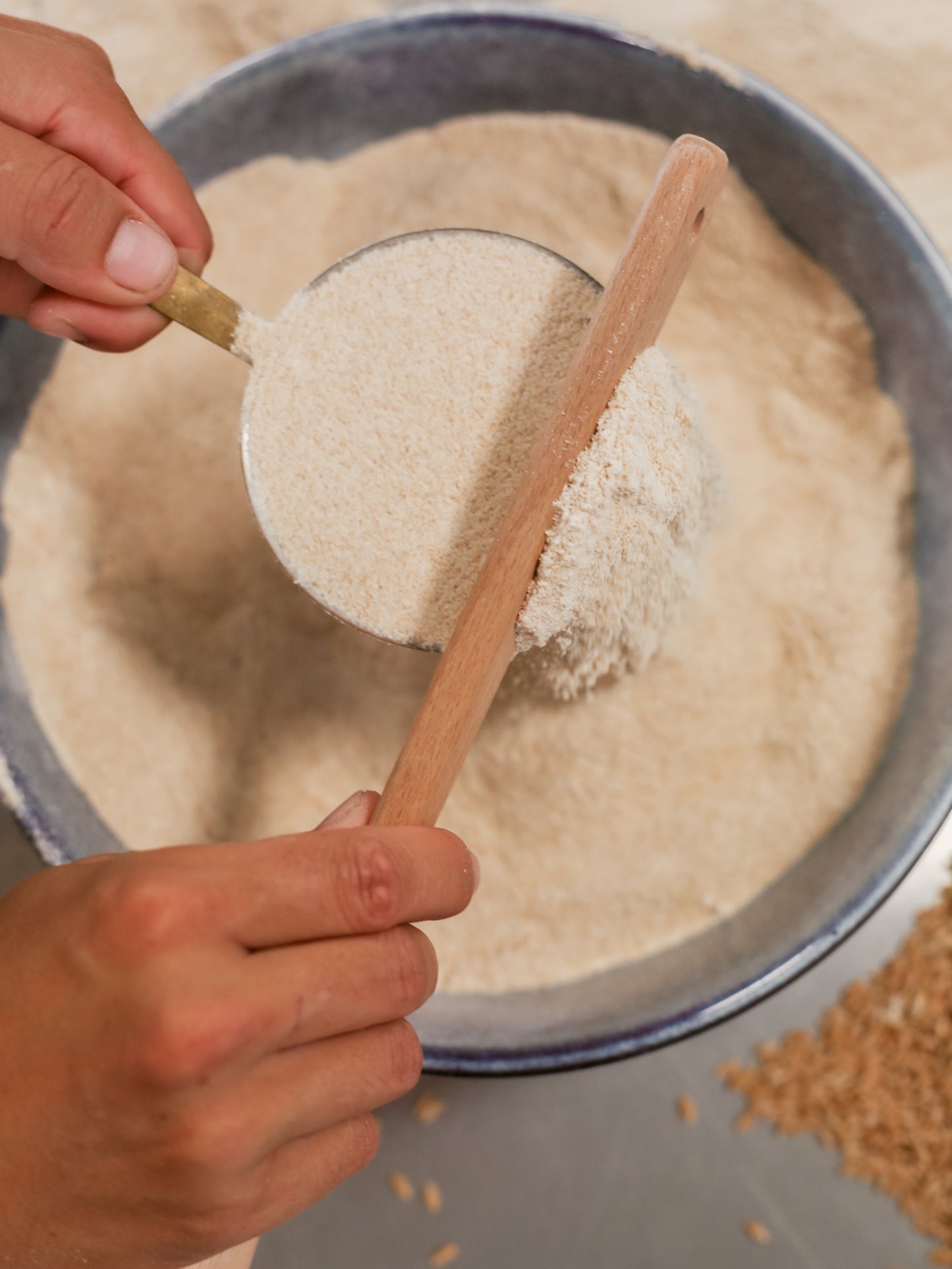 Stone-milled flour from the Complete Flour Box by Sieda Milling, shown being scooped for everyday home baking