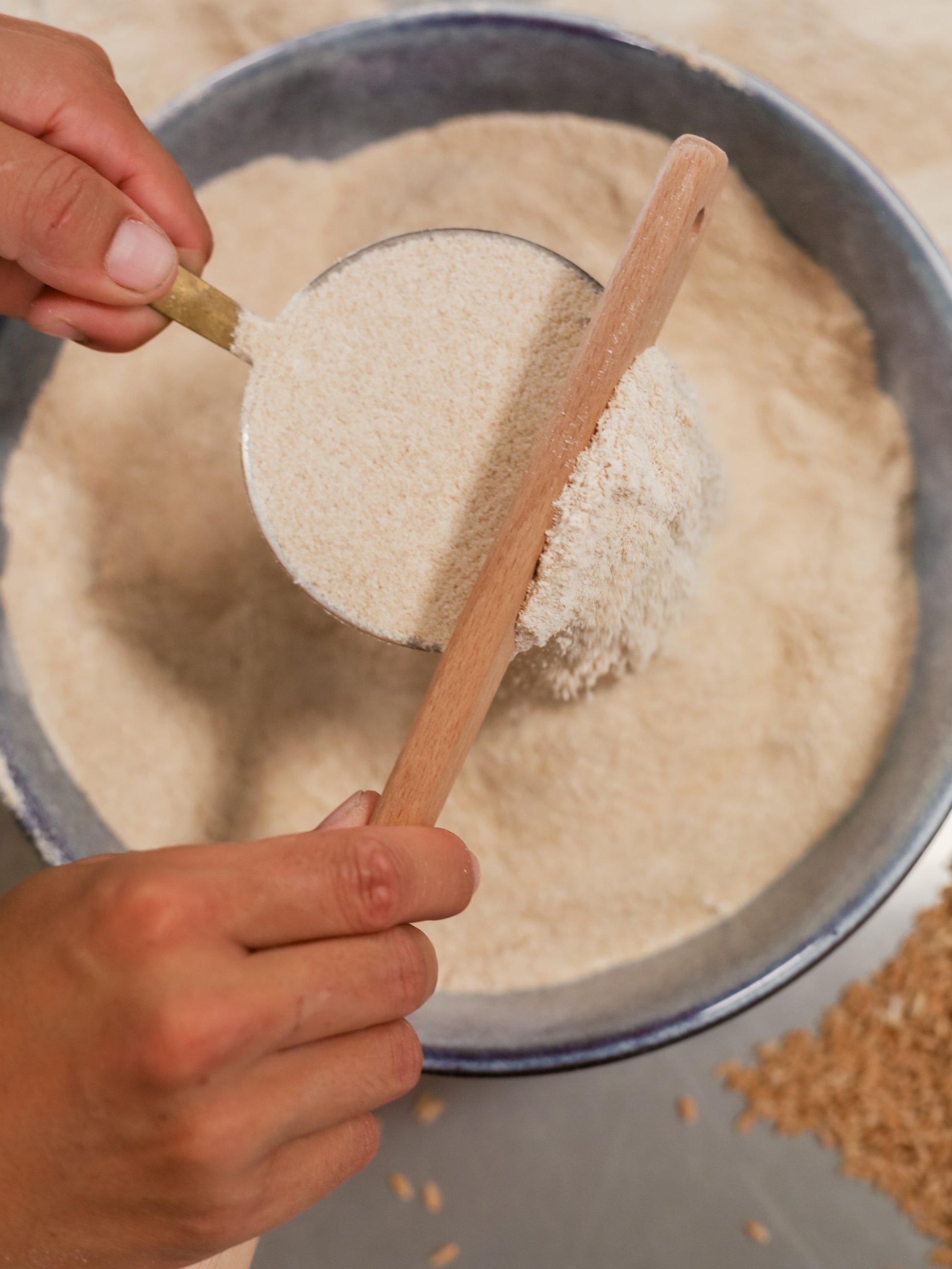 Stone-milled flour from the Complete Flour Box by Sieda Milling, shown being scooped for everyday home baking